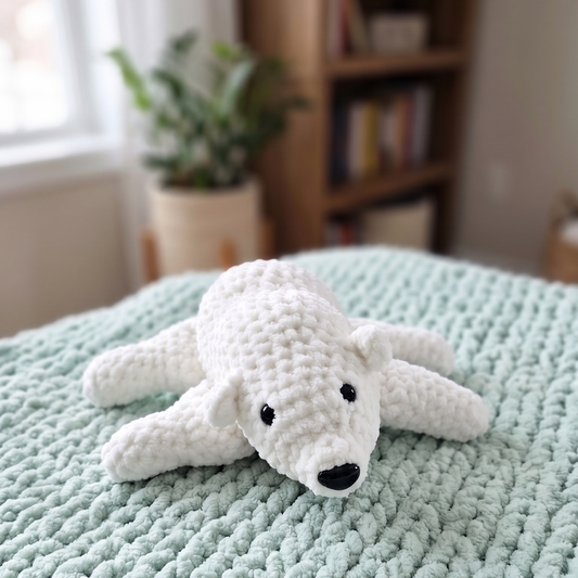 Plush crochet velluto polar bear on bed